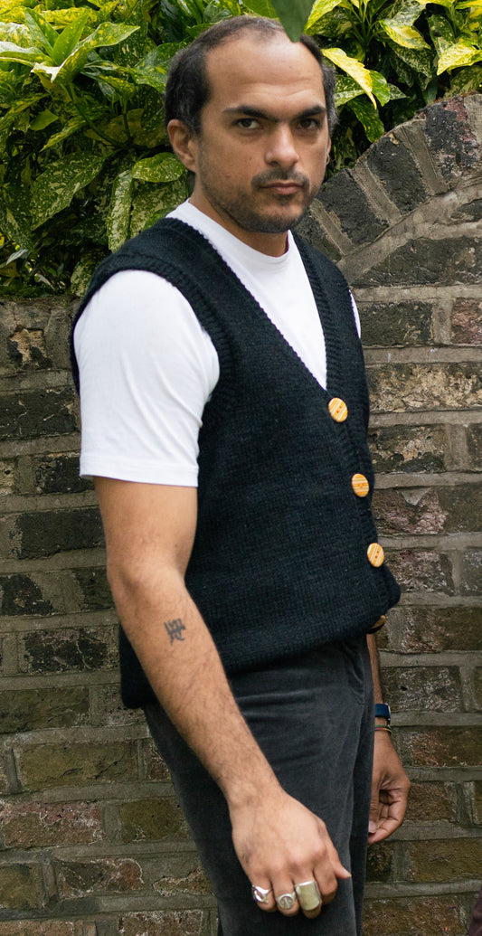 Black Buttoned Vest with recycled skateboard hand made buttons on a model, London brand
