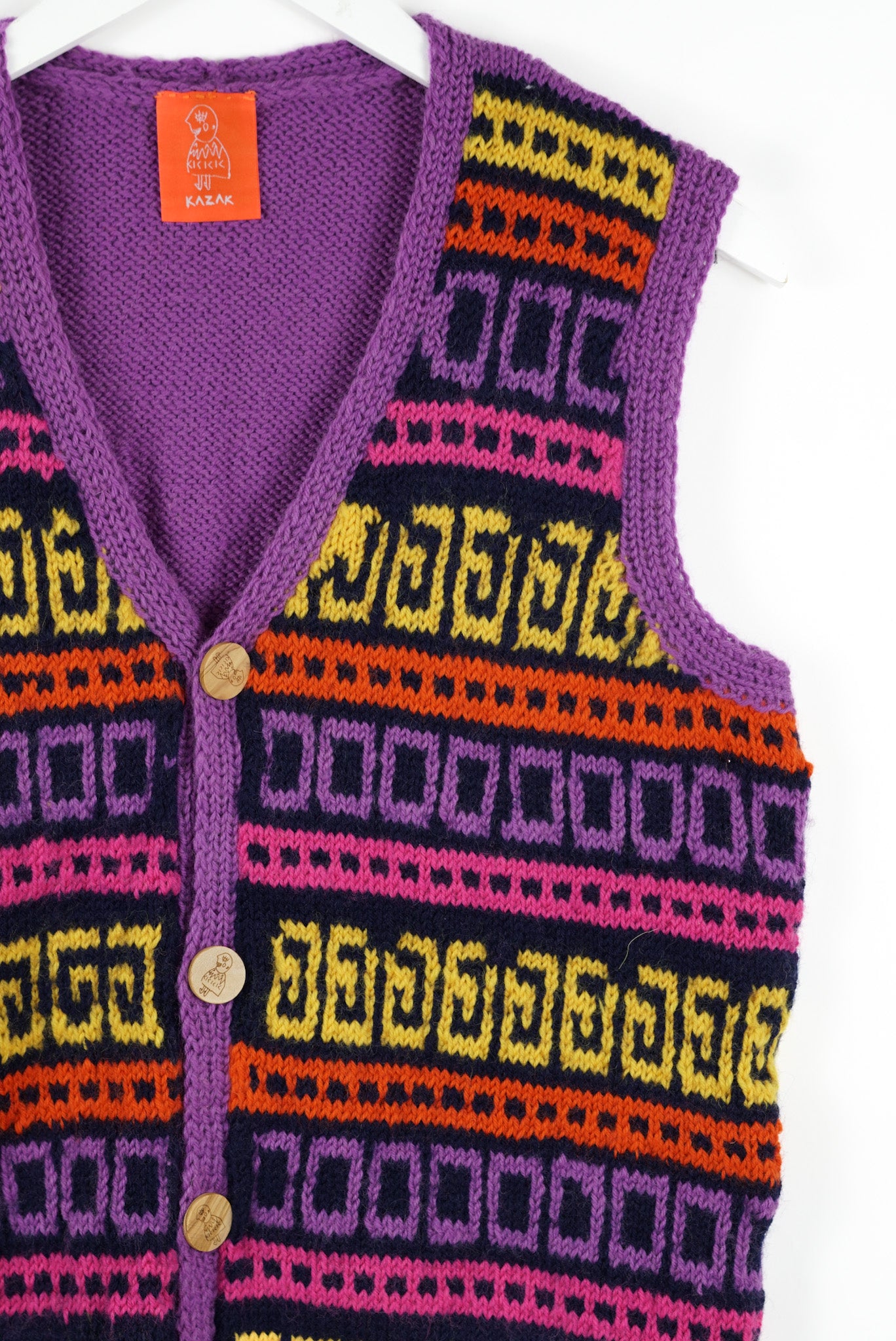 Colorful patterned vest with geometric design on a white background