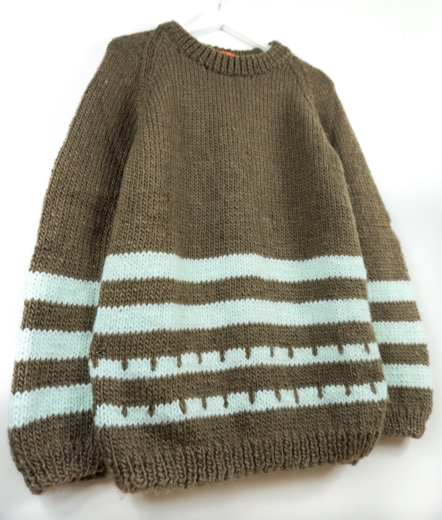 Brown sweater with light blue stripes on a white background