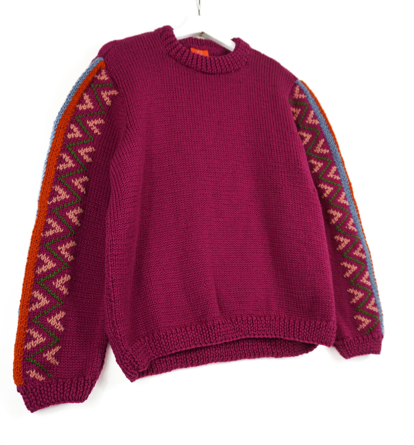 Purple Jumper with heritage style patterns on its arms, white background