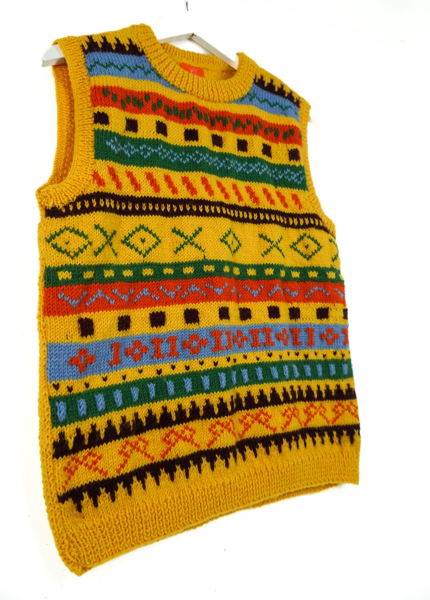 Colorful knitted vest with geometric patterns on a white background