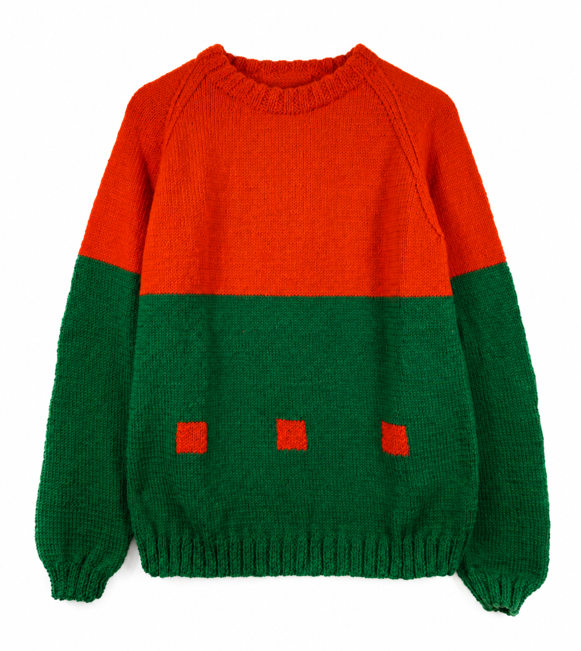 Orange and green hand-knitted crewneck sweater with raglan sleeves and three small orange squares across the green lower section, shown against a white background.