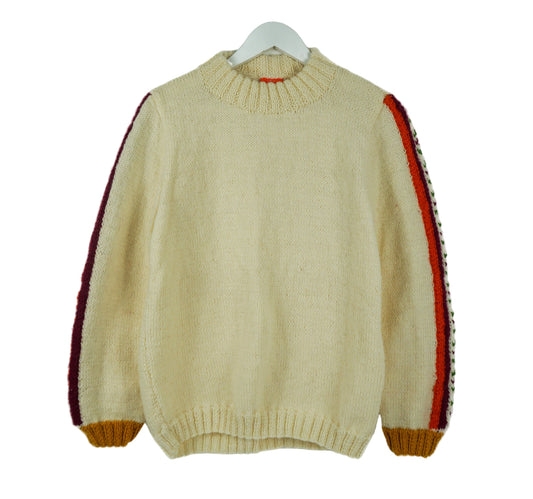 Beige sweater with red and brown accents on a white background