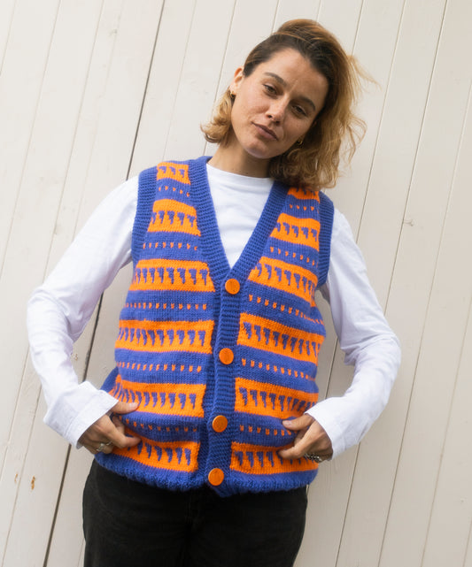 Fair Isle Sleeveless Cardigan with unique orange buttons on it, one off from a London brand