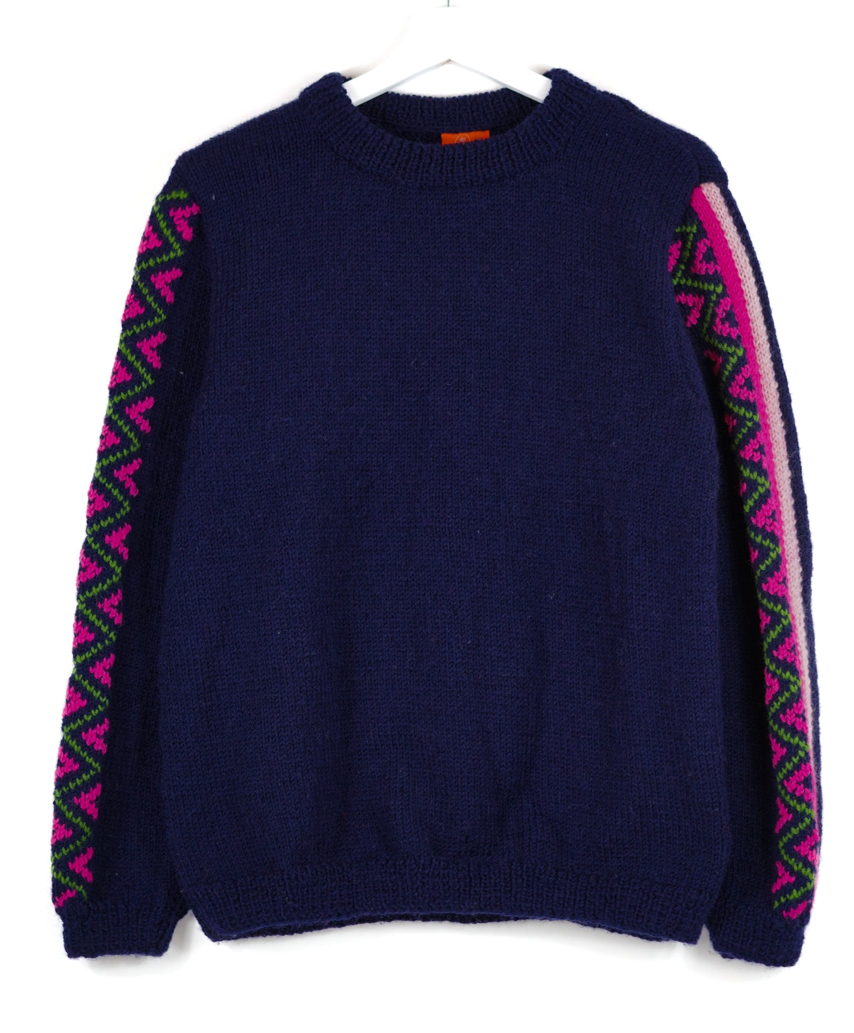 Navy Blue jumper with heritage patterns on its sleeves 