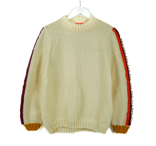 Beige sweater with red and yellow accents on a white background