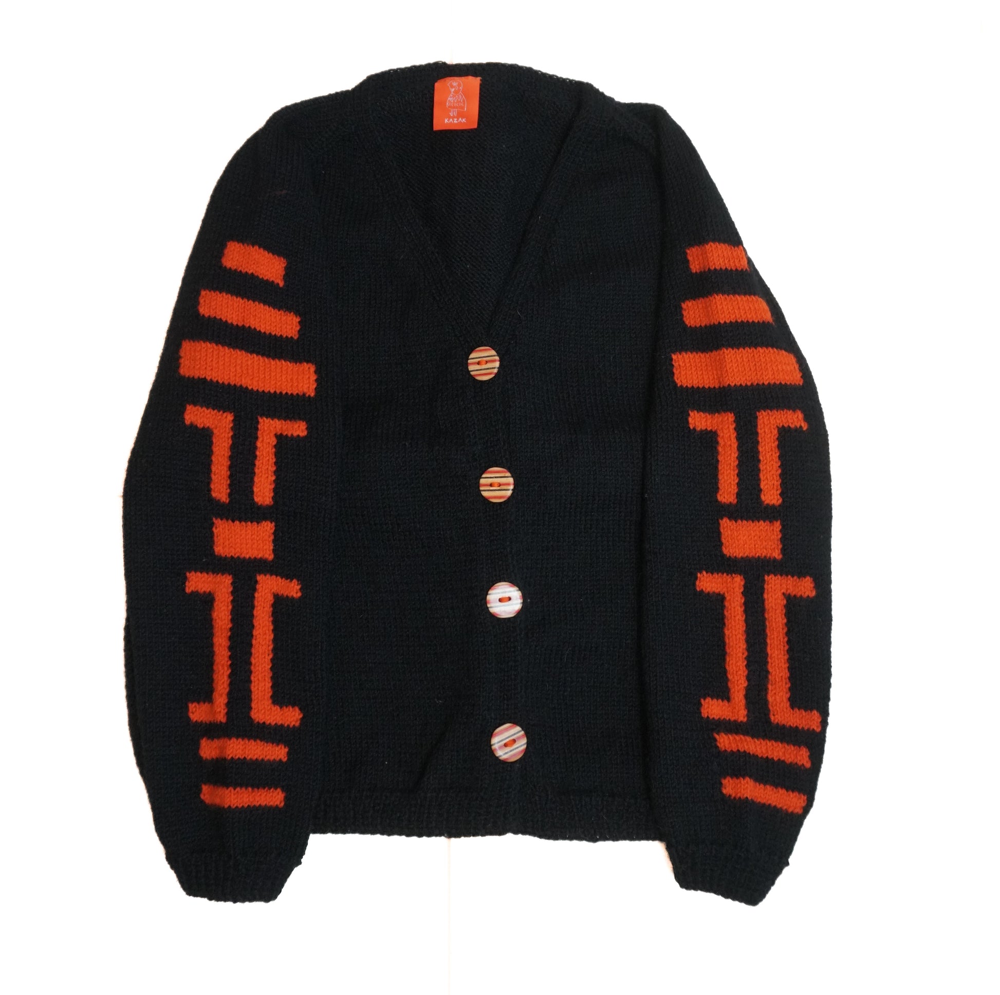 Black cardigan with orange patterns on a white background