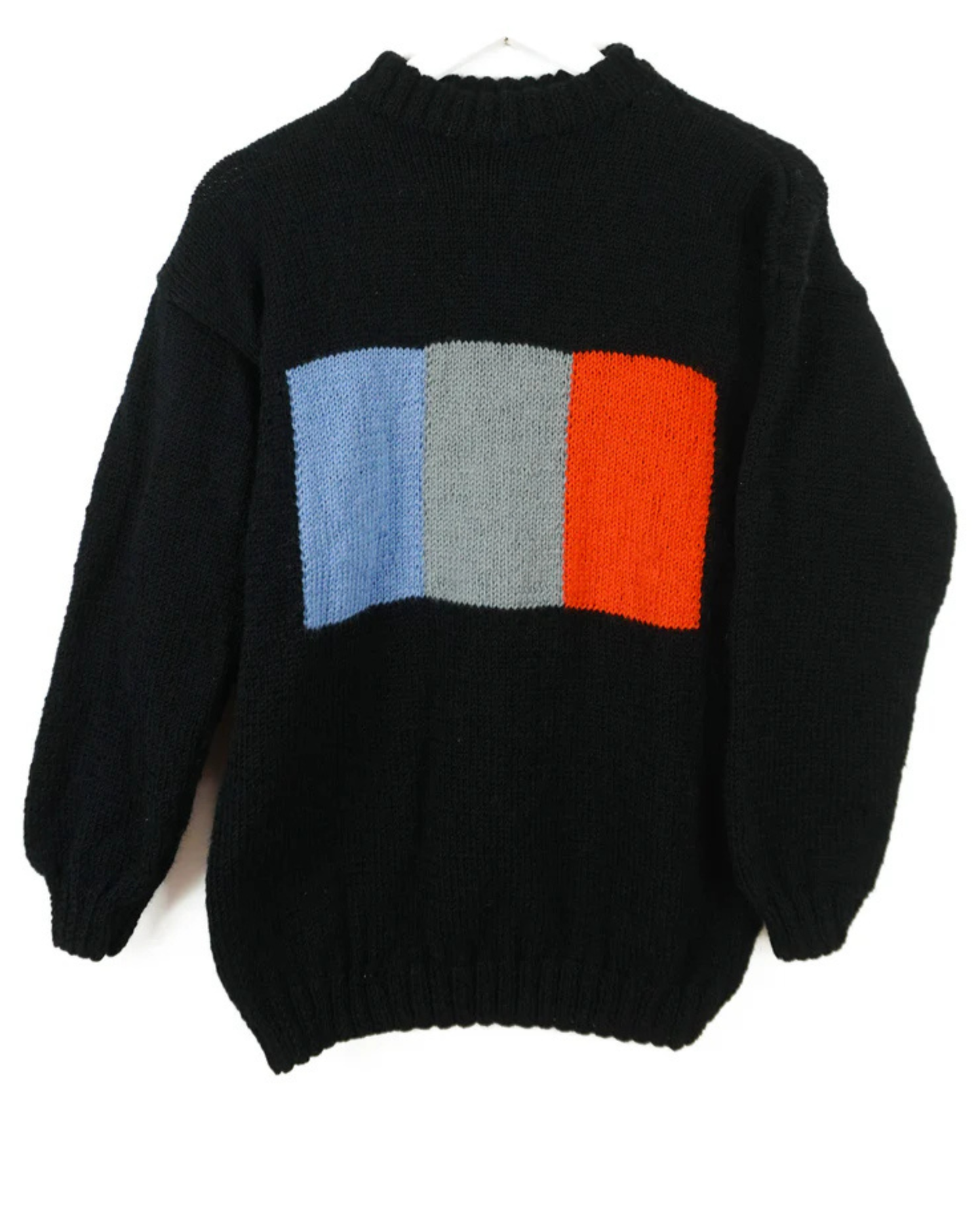 Black sweater with a colorful square pattern on a white background