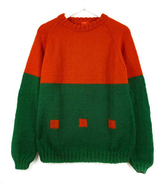 Color-blocked sweater with orange top and green bottom on a white background