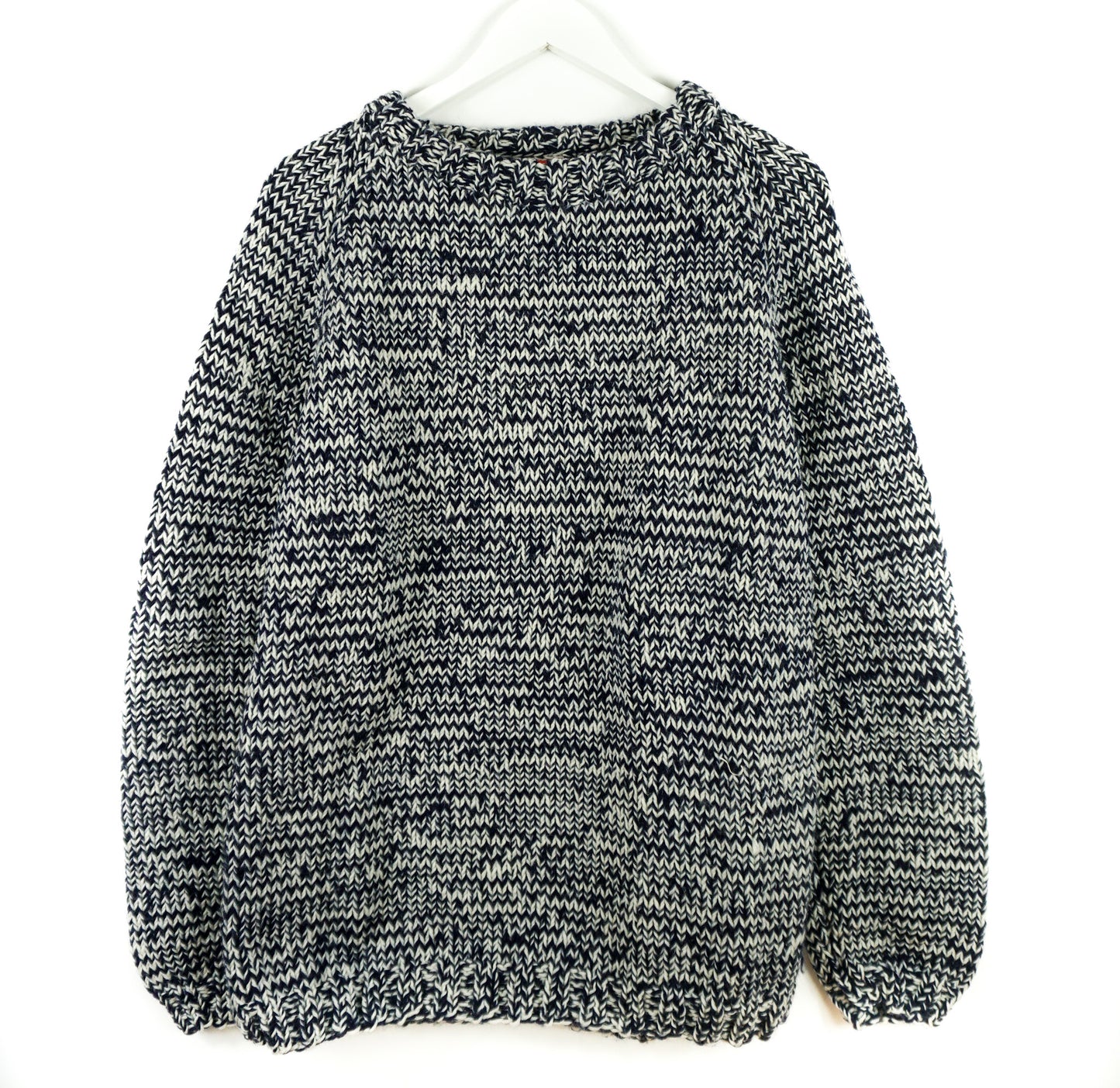 Black and white patterned sweater on a white background