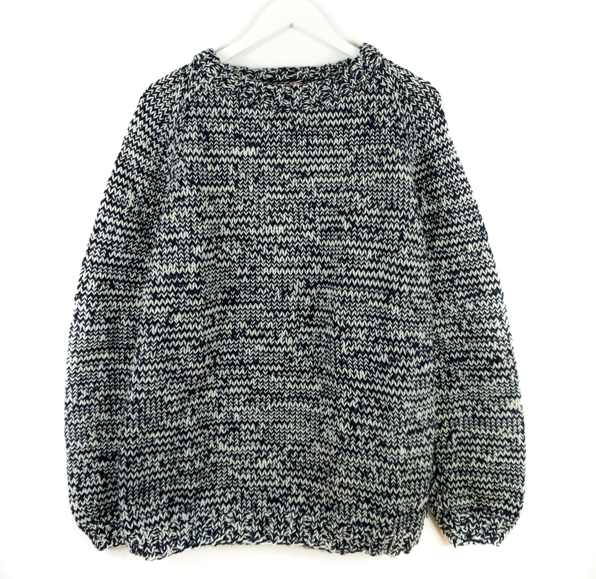 Black and white patterned sweater on a white background