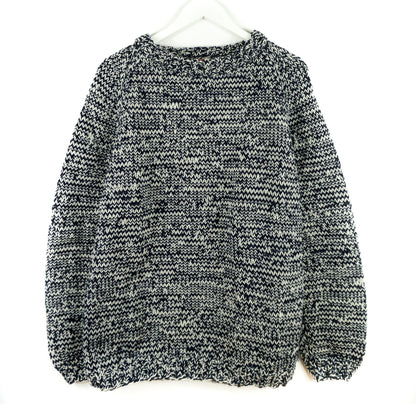 Black and white patterned sweater on a white background