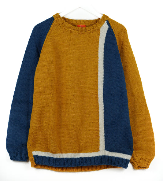 Color-blocked sweater with mustard yellow and blue sleeves on a white background