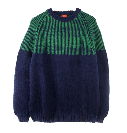 Navy and green sweater on a white background