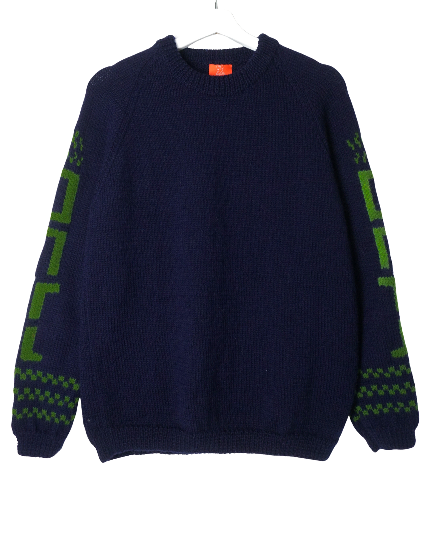 Navy blue sweater with green patterns on sleeves against a white background