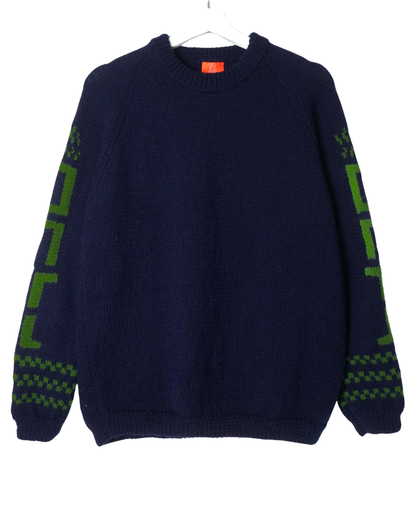 Navy blue sweater with green patterns on sleeves against a white background