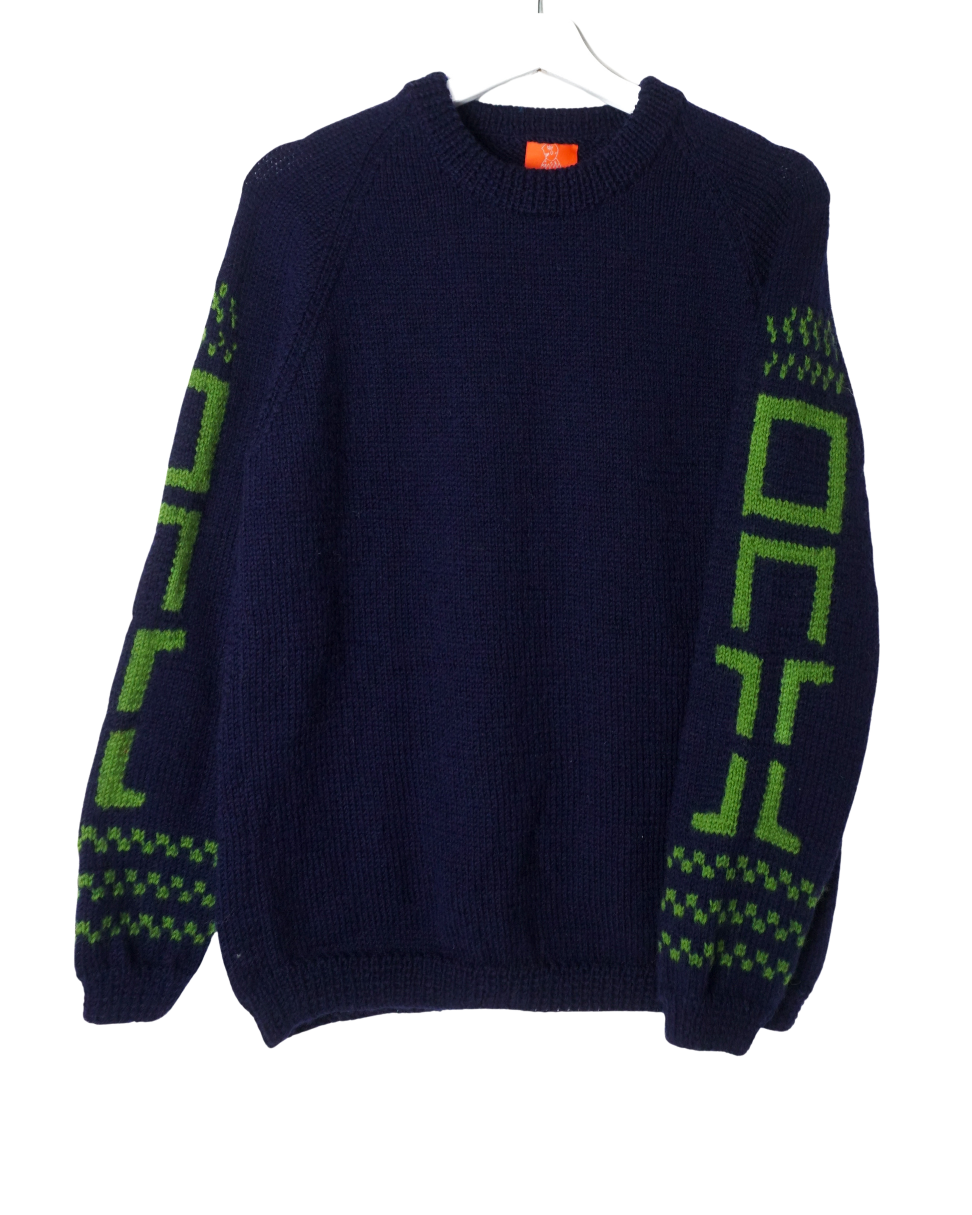 Navy blue sweater with green geometric patterns on sleeves, displayed on a white background.
