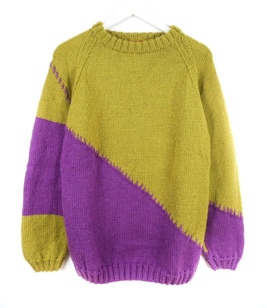 Color-blocked sweater with purple and green sections on a white background