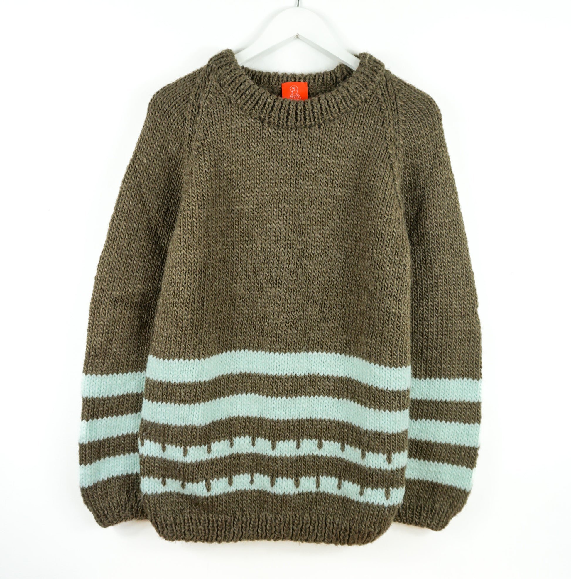 Turqouise patterns brown heavy jumper on a white back ground