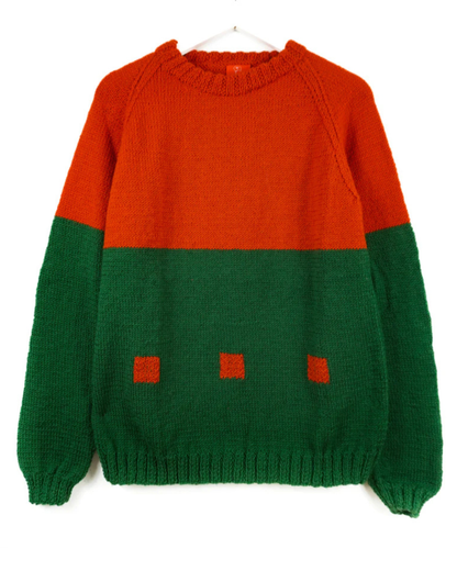 Two-tone red and green sweater on a white background