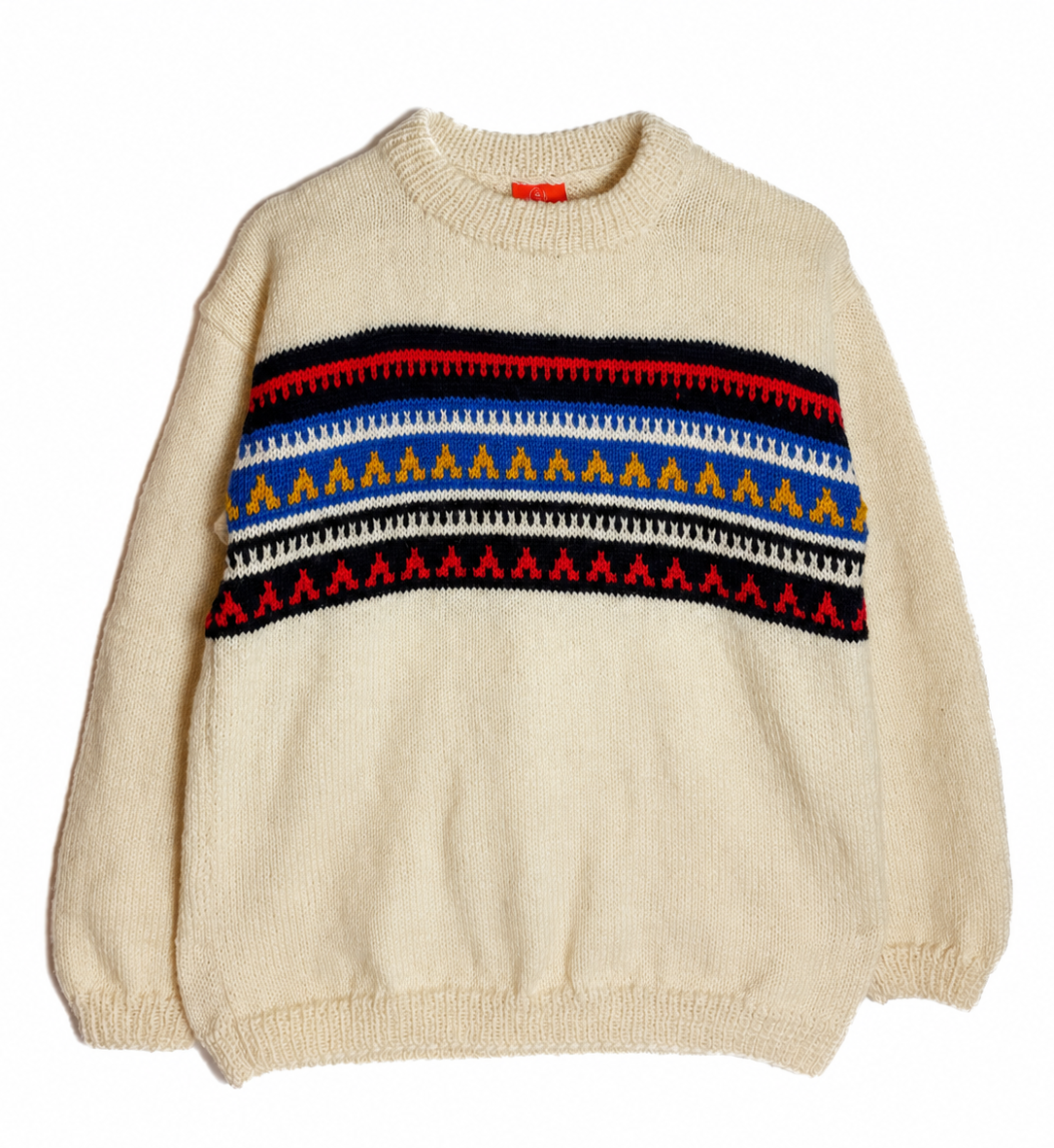 A cream-colored knit crewneck sweater featuring a colorful geometric Fair Isle pattern across the chest with red, blue, yellow, black, and white stripes.