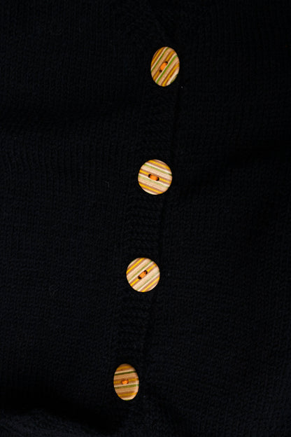 Black Buttoned Sleeveless Cardigan, close-up of buttons made from recycled skateboards, by Kazak Woolies