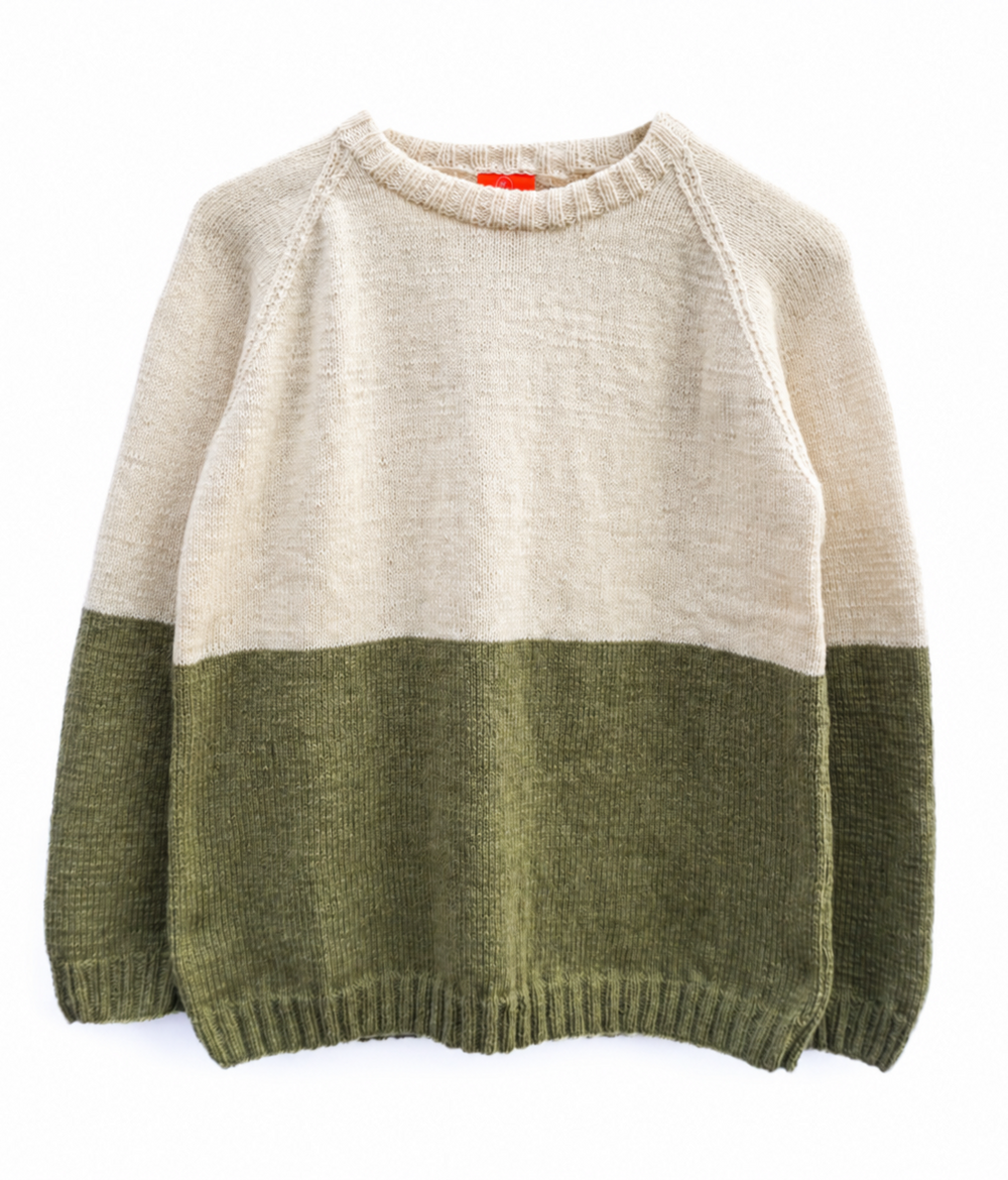 A colorblock knit sweater with a cream upper body and sleeves, and an olive green lower body and sleeves, laid flat against a white background.