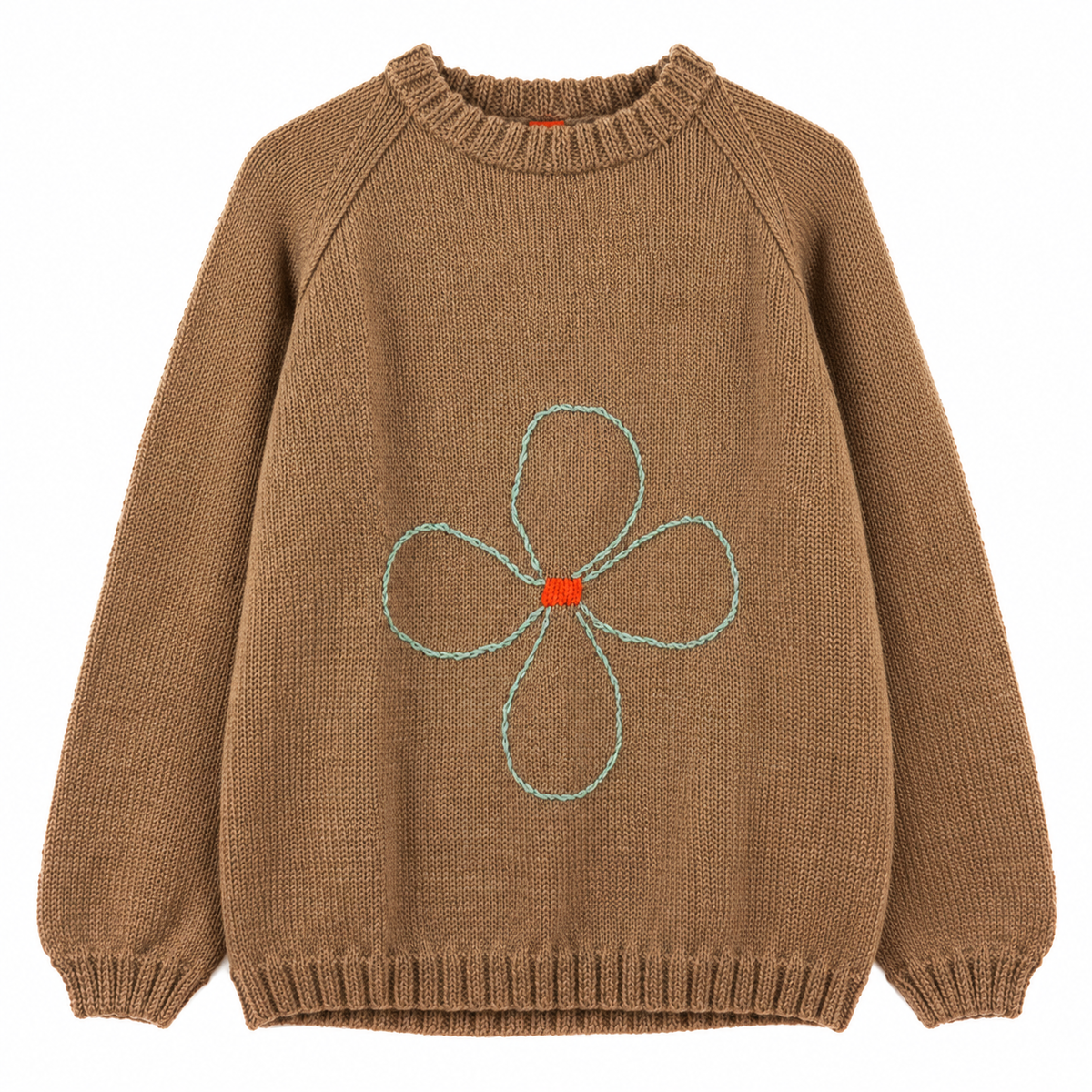 Light brown jumper with a flower knitted on it, over a white background