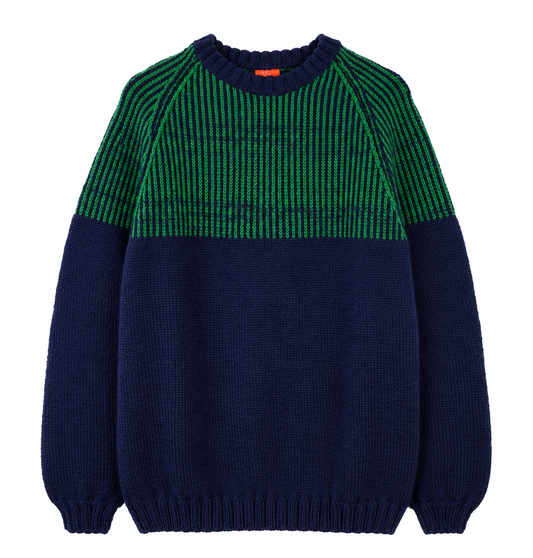 A color-blocked knit sweater with a dark navy blue body and sleeves, and a green and black striped yoke across the chest, shown flat on a white background.