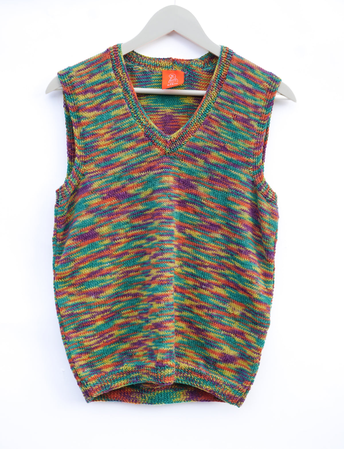 A sleeveless V-neck knit sweater vest with a multicolor marled pattern of green, purple, orange, and yellow, hanging on a white hanger against a white background.