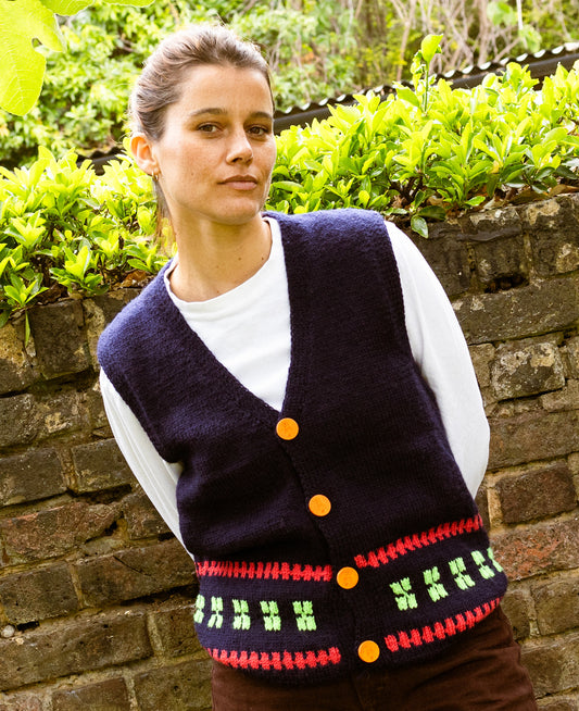 Logo Buttoned Sleeveless Cardigan, one-off hand-knitted sleeveless cardigan by Kazak Woolies, worn by a model