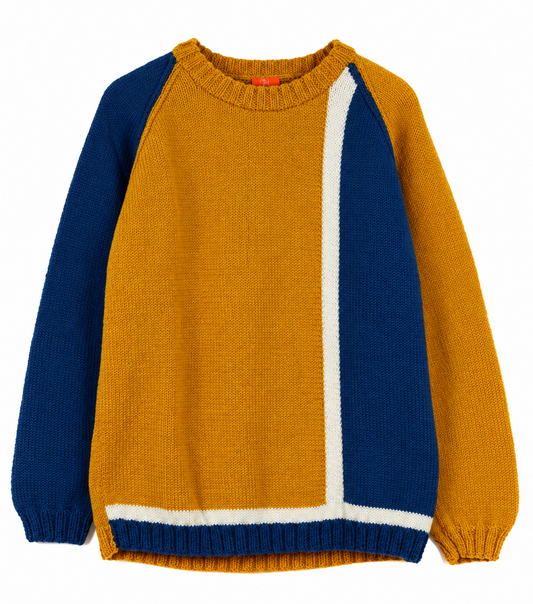 A color-blocked knit sweater with a mustard yellow body, navy blue raglan sleeves and hem, and a vertical white stripe running from the collar to the hem.