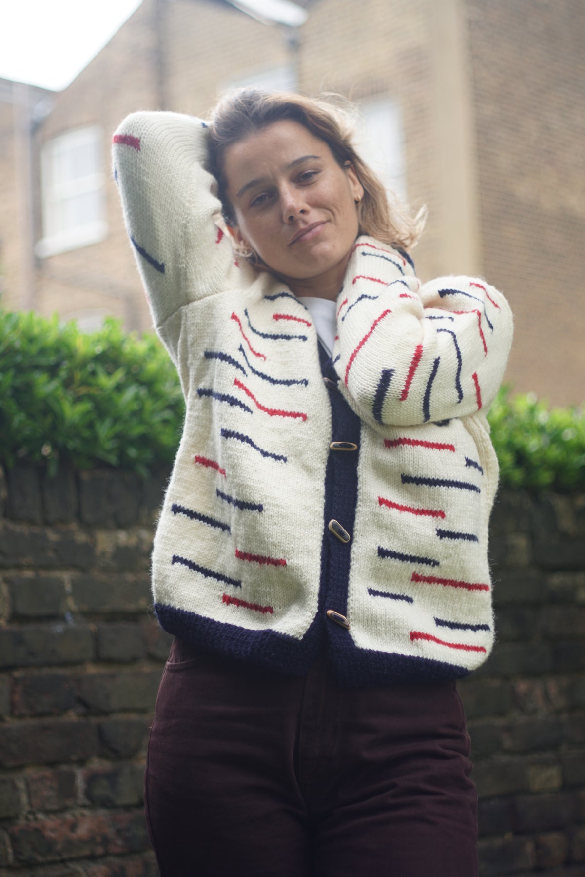 Navy Red Lined Cardigan, one-off hand-knitted cardigan by Kazak Woolies, worn by a model