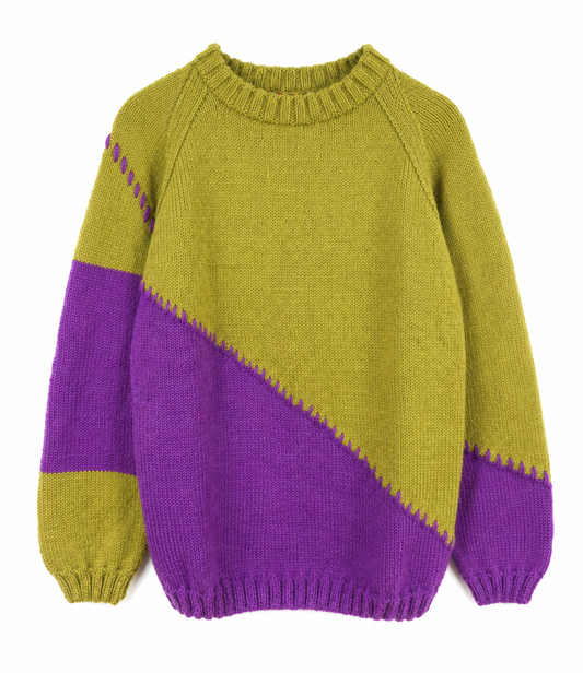 A hand-knit long-sleeve sweater with a color-blocked design, featuring a mustard yellow body and sleeves with a diagonal purple section on the lower half and upper sleeve, set against a plain white background.