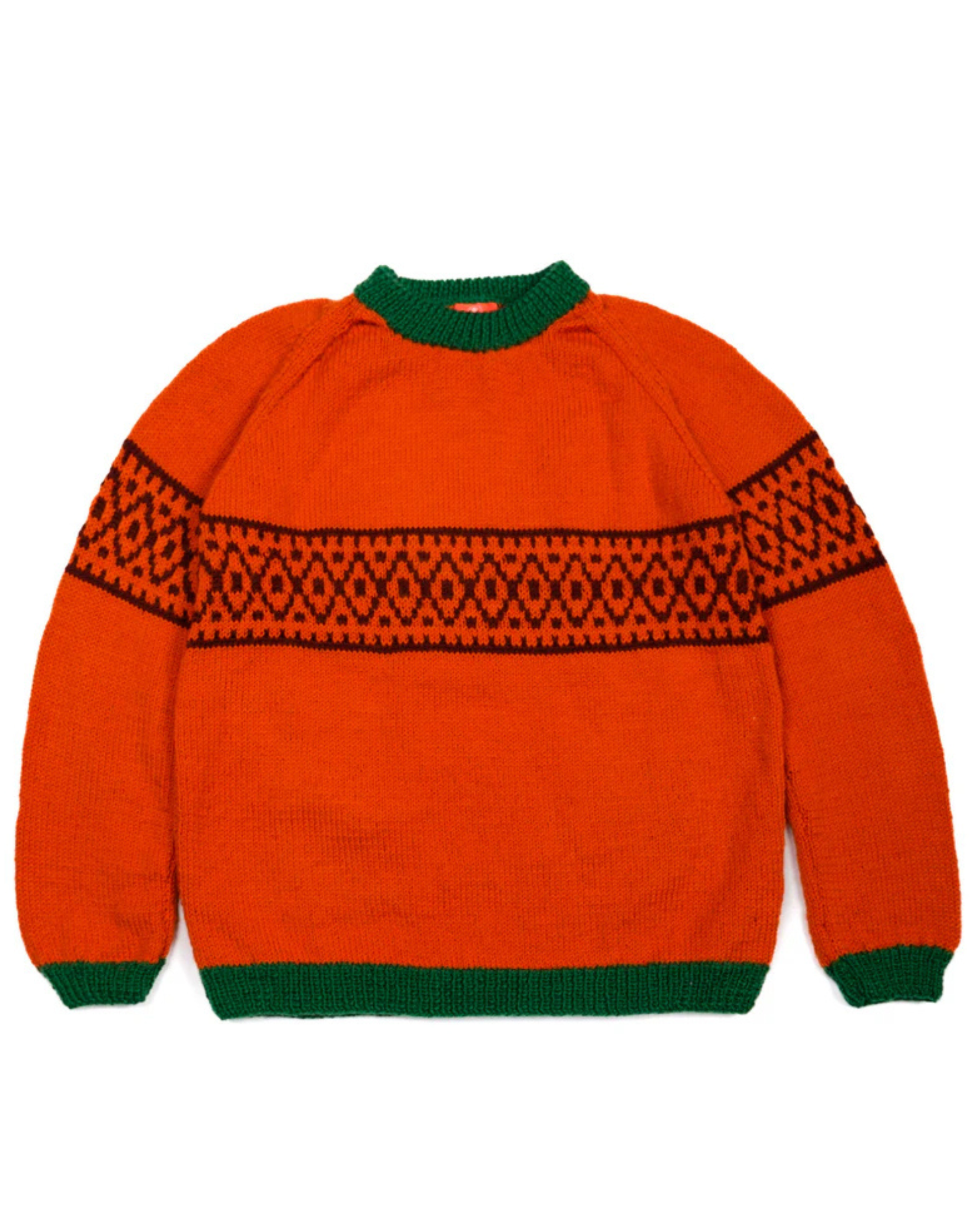Orange sweater with green trim and geometric pattern on a white background