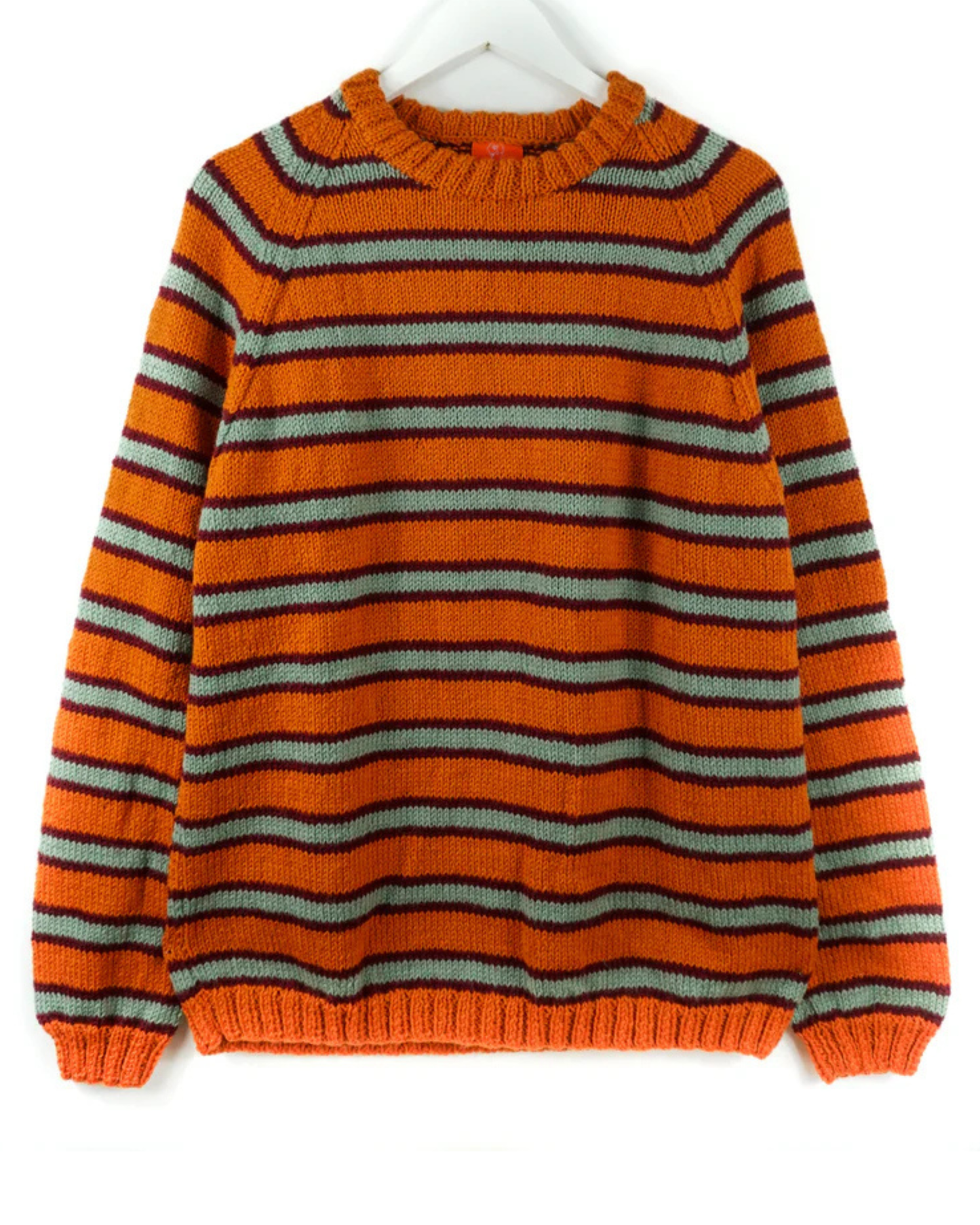 Orange and gray striped jumper on a white hanger