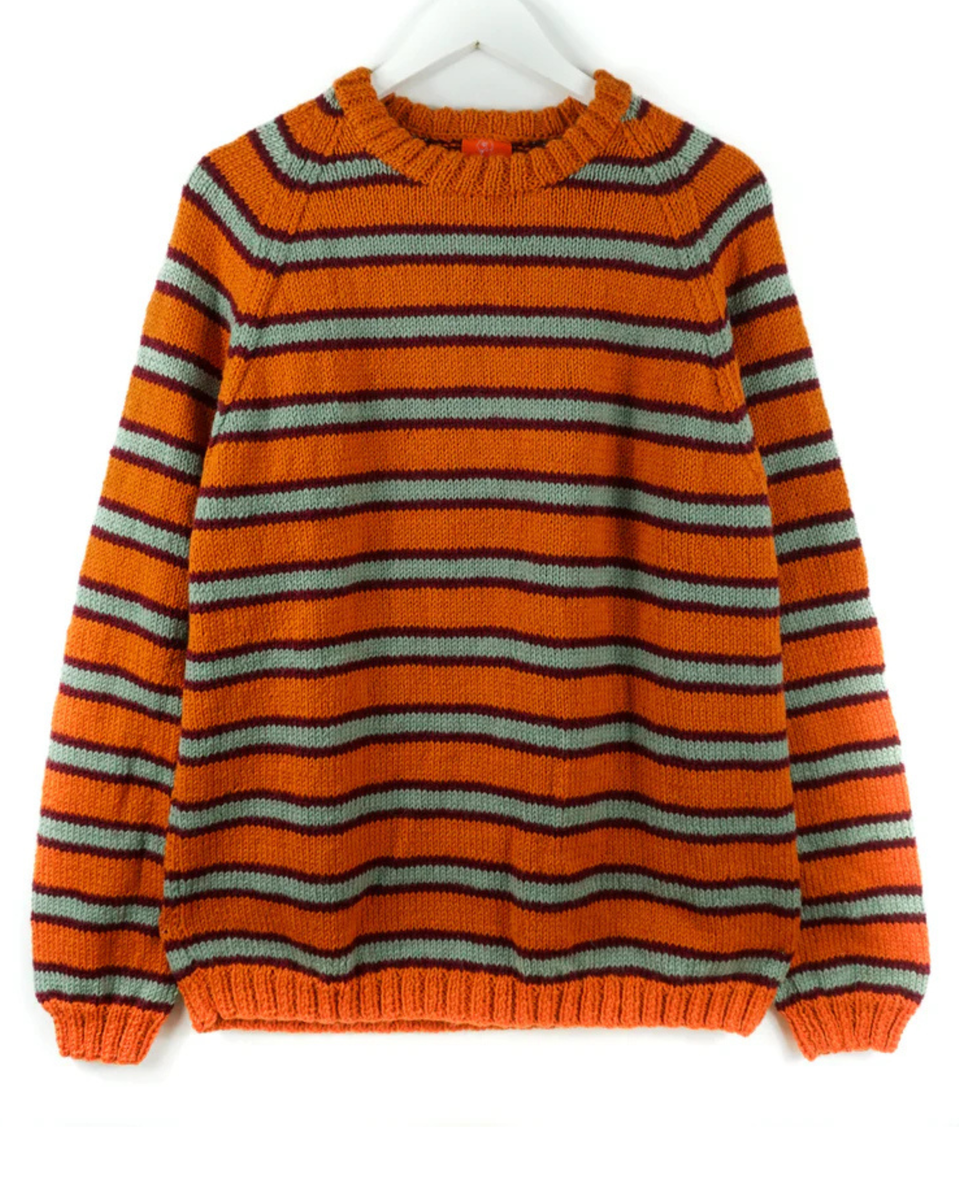 Orange and gray striped jumper on a white hanger