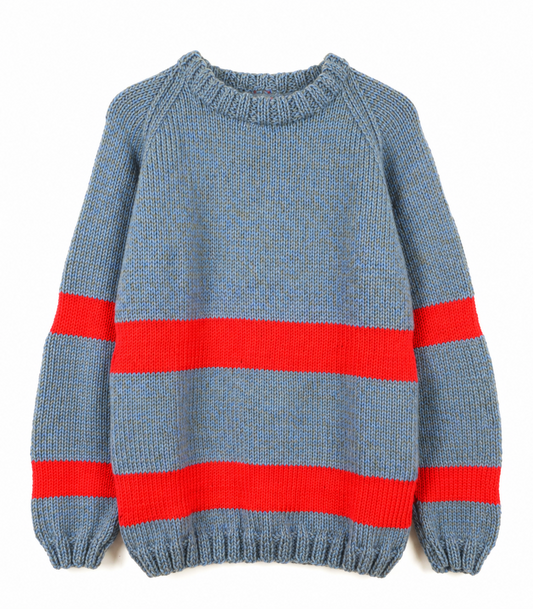 Chunky blue-grey knitted sweater with bright red-orange horizontal stripes across the body and sleeves, featuring a ribbed crew neck, cuffs and hem, displayed against a white background.