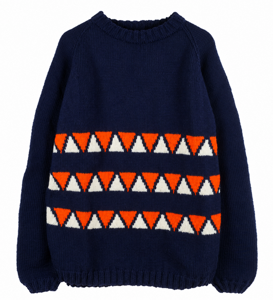 A navy blue knit crewneck sweater featuring horizontal geometric patterns of orange and white triangles across the chest, displayed on a clean white background.